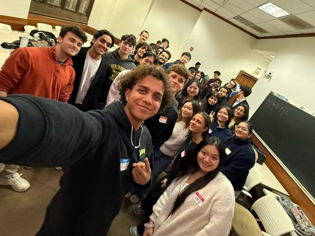 Guests crowding into a group selfie at a Sip & Scale meetup in Chicago