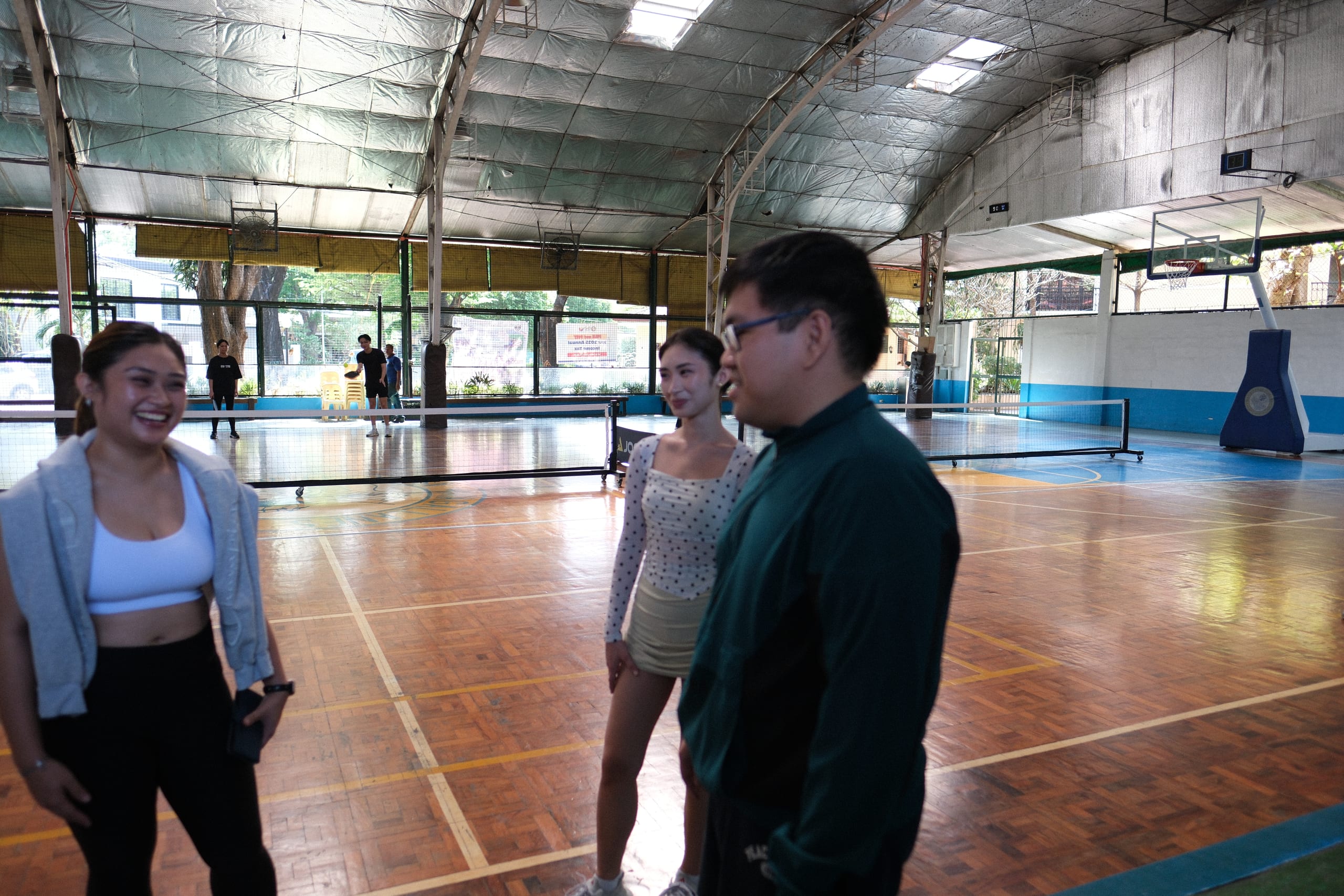 Participants laughing and talking beside the court