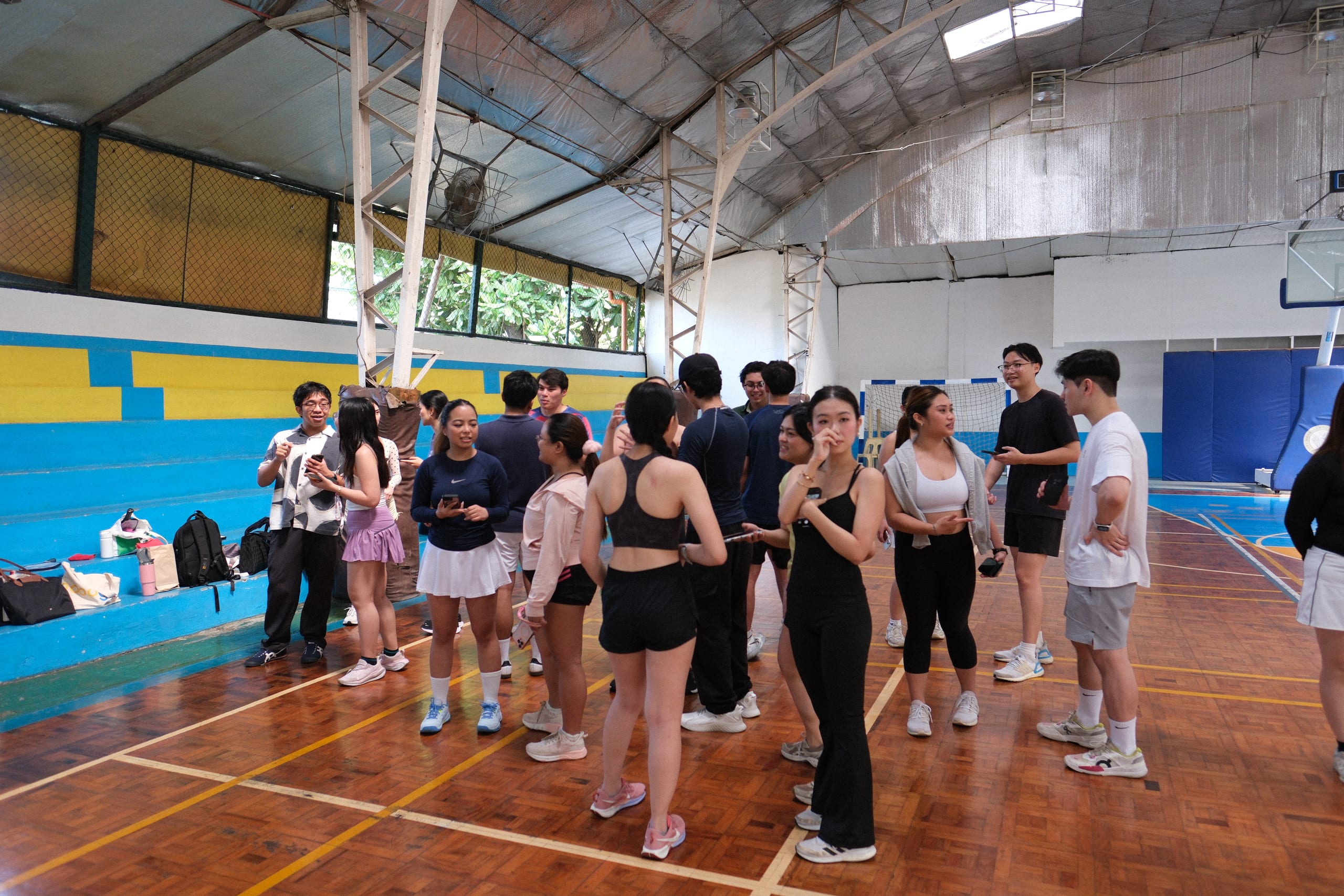 Small groups talking together on the indoor court
