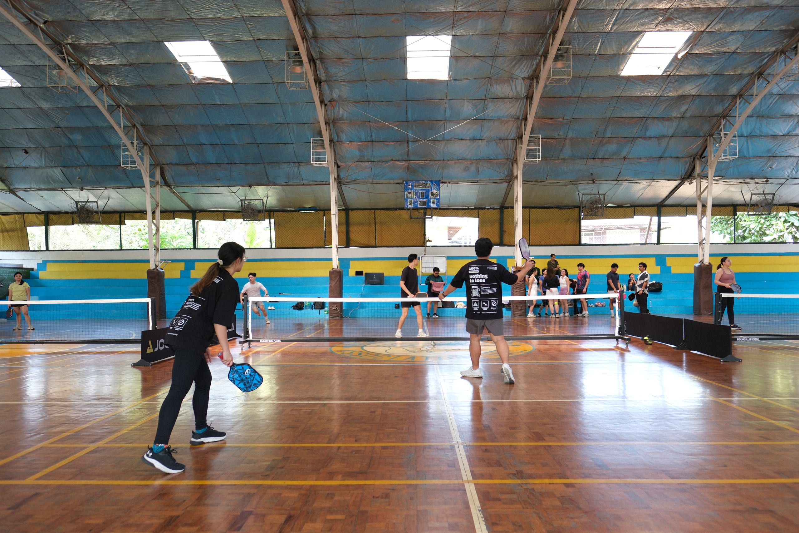 Doubles players preparing for a pickleball return