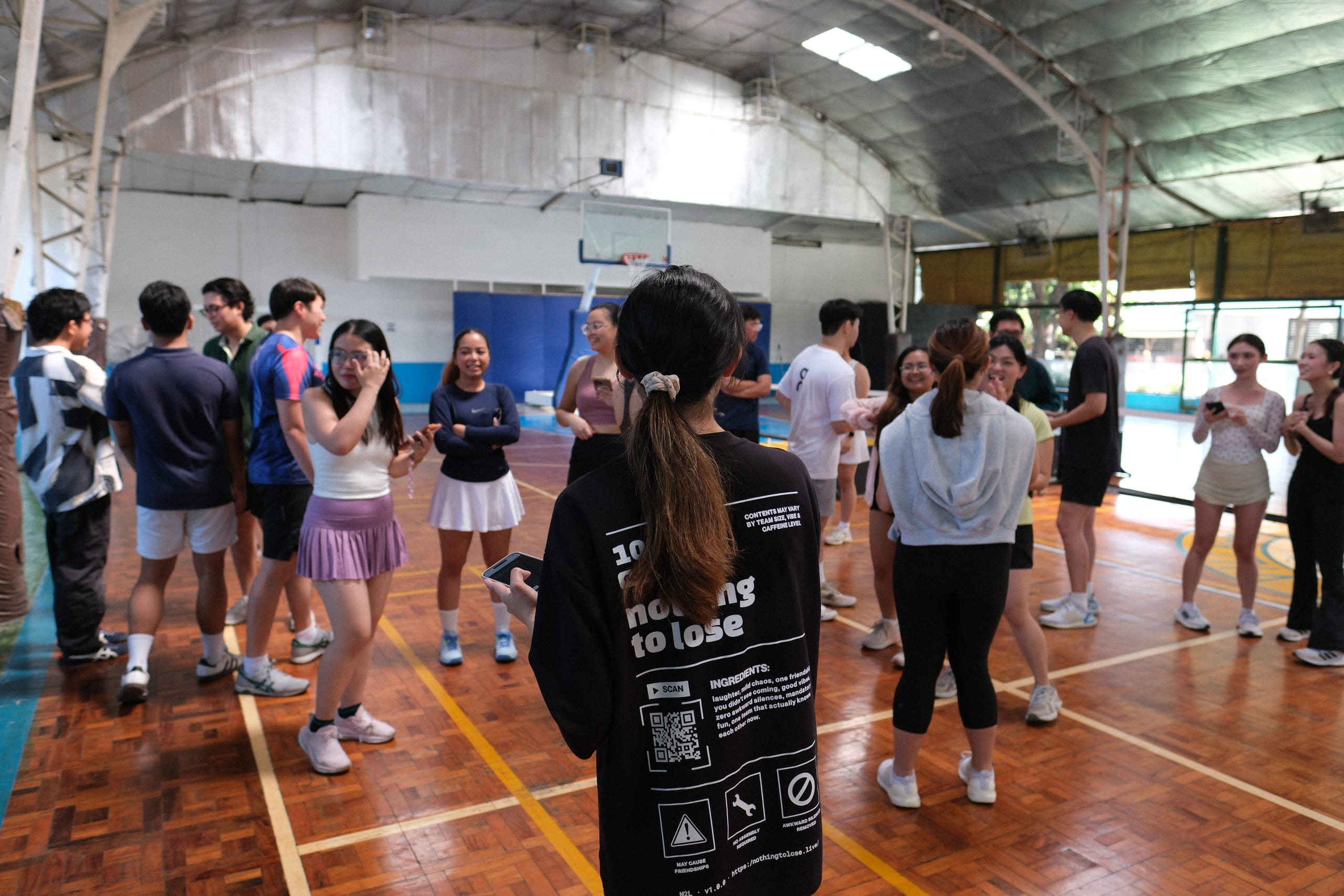 Participants gathering in a circle on the court