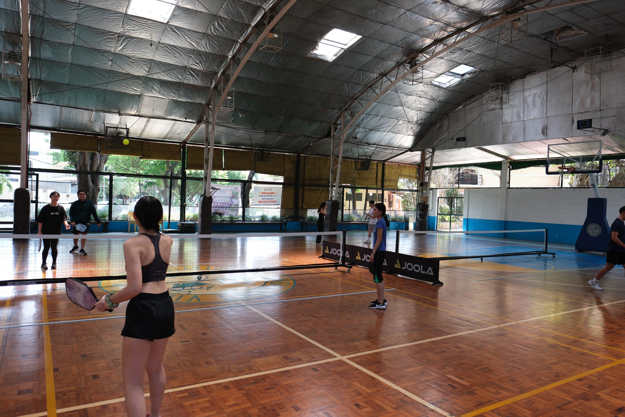 A pickleball player watching the ball beside the net